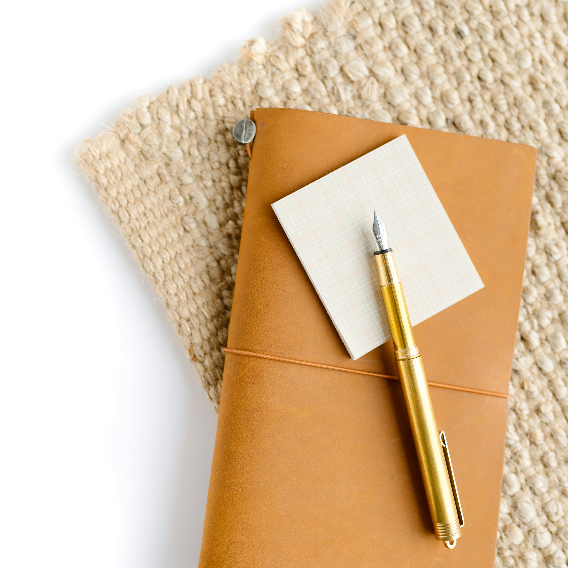 Leather notebook and gold pen
